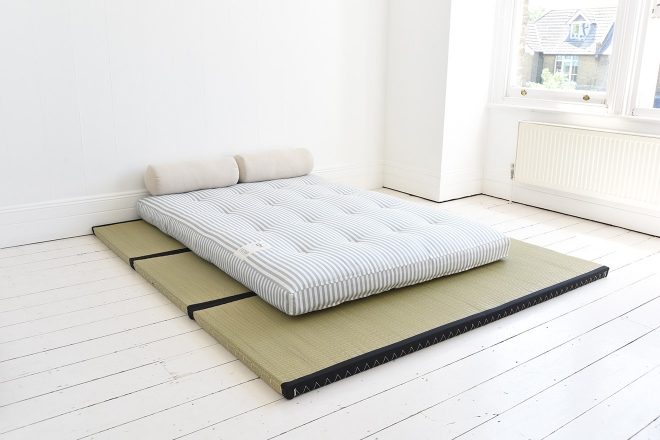 futon mattress on slightly raised wooden floor