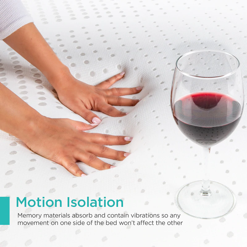 two hands pressing down on memory foam mattress with red wine glass