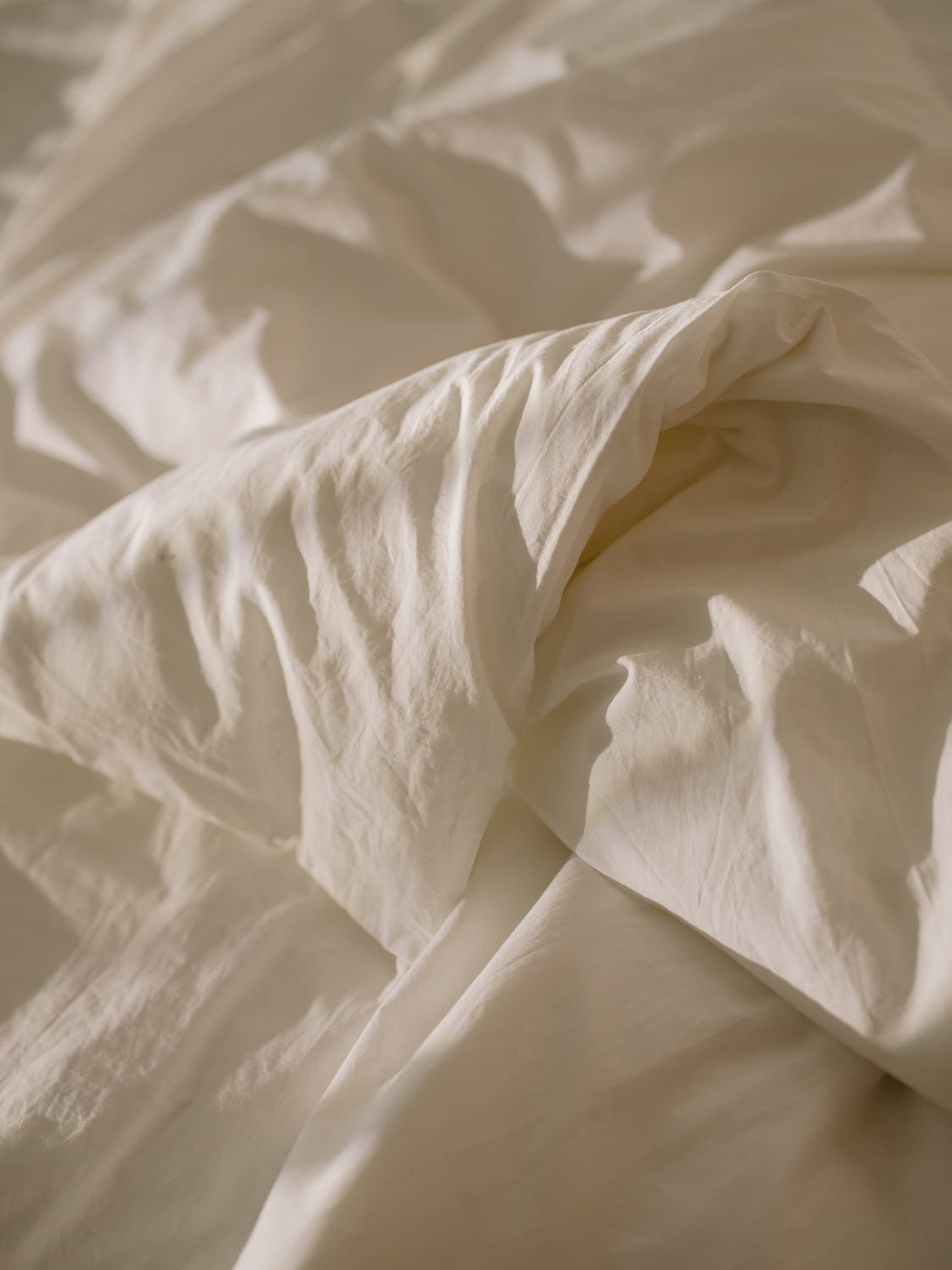 white bed sheets with white duvet 
