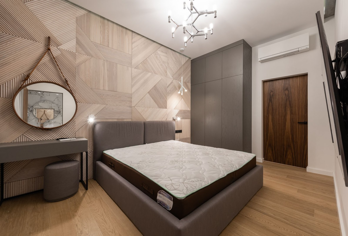 gray accent bedroom with wooden walls and door